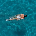 overhead shot of a woman swimming in a pool