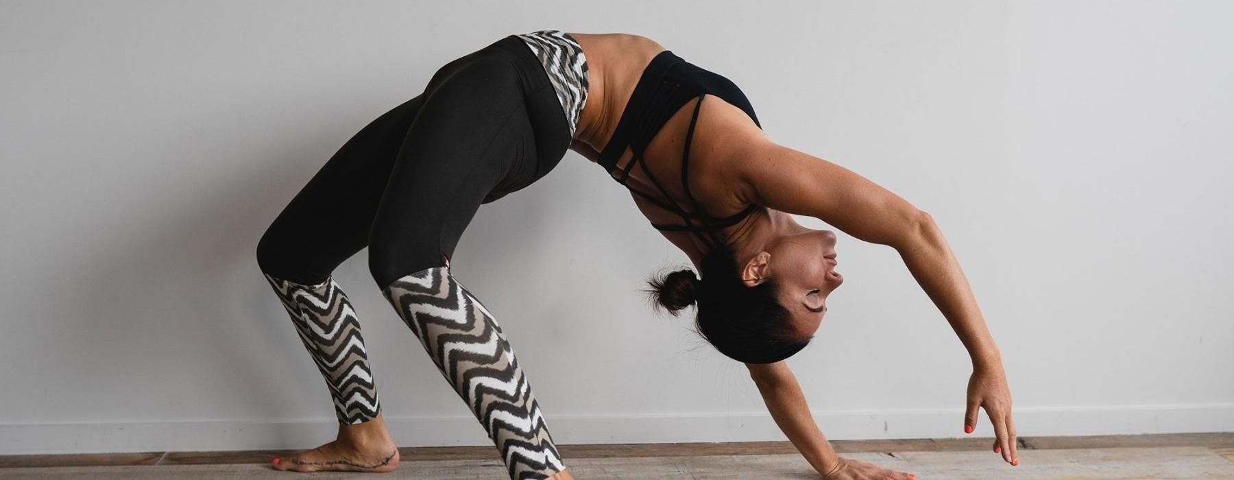 woman bending over backwards in an exercise studio
